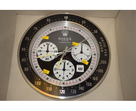 A Rolex Oyster Cosmograph wall clock in steel case, battery operated.