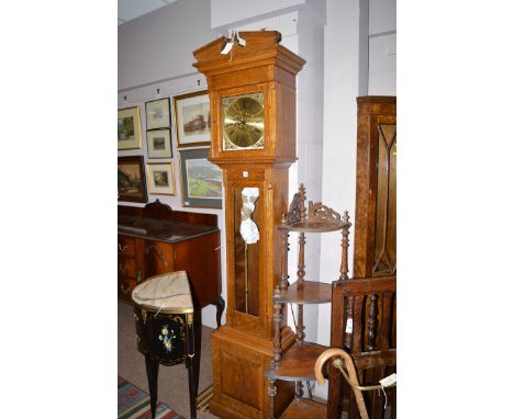 A reproduction oak grandfather clock, with swan neck pediment and brass finial over a glazed door enclosing brass roman dial,