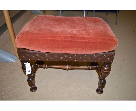 An early 17th Century style rectangular stool with velour cushion on top of leather with turned legs and joined by stretchers