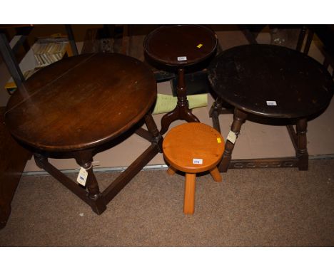 Two oak occasional tables; together with a mahogany wine table; and an oak milking stool.  (4)