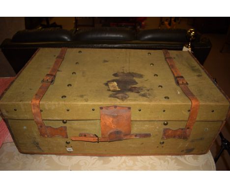 A canvas covered trunk, with leather straps and leather binding, by Army & Navy, London.
