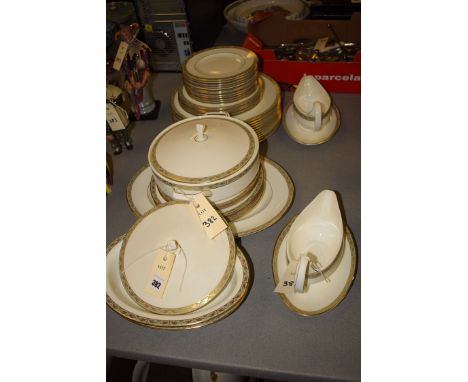 A Wedgwood 'Marina' part dinner service with green and gilt borders, comprising; dinner plates; tea plates; gravy boats and s