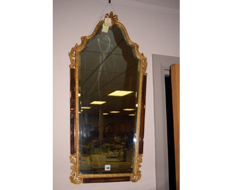 A modern gilt and metal mirror with bevelled glass, mirrored copper to sides and base.