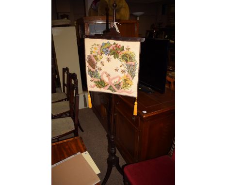 A Victorian mahogany pole screen, with tapestry on turned support, raised on three splayed legs.