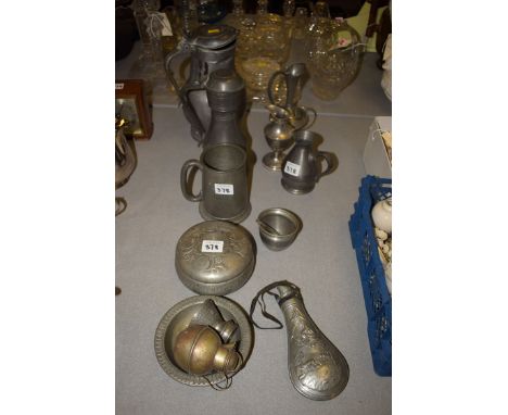 Pewter ware, to include; a gunpowder flask; two lidded jugs; a tankard; and others.