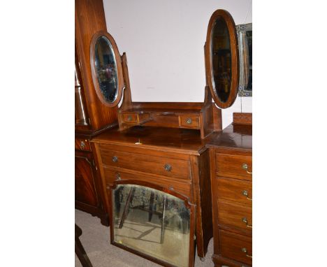 A late 19th Century stained wood dressing chest with swing mirror with two oval mirrors to the side, two jewellery drawers an