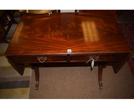 A reproduction mahogany sofa table, 35 1/2in. wide with flaps down.