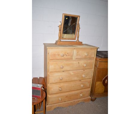 A modern pine chest two over four long drawers, 36in wide; and a swing toilet mirror (plate broken).