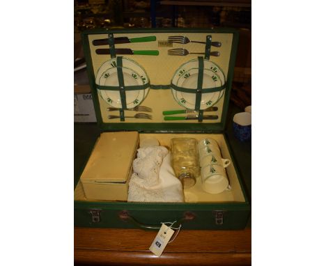 A Brexton picnic set for four place settings, comprising: teacups, saucers, sandwich plates, forks and knives, and others ite