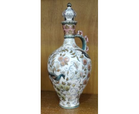 A Zsolnay Pecs lidded vase with floral and bird decoration, 27cm high, (crack to base of handle where it joins the body, and 