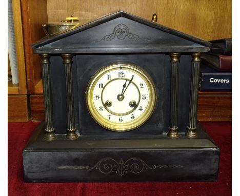 A black marble-cased striking mantel clock of architectural design, 29cm high, 34cm long. 