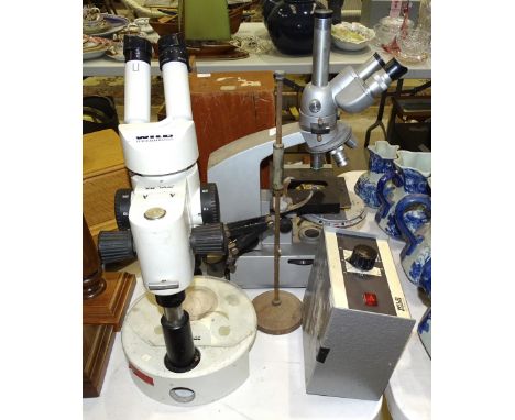 A Wild Heerbrugg binocular microscope, a Reichert binocular microscope, (both a/f), a microscope marked GS707, in wooden case