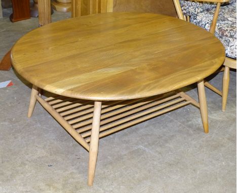 An Ercol oval coffee table with magazine shelf beneath, 98.5 x 82.5cm, 44cm high. 