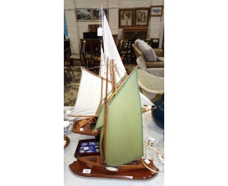 A mid-20th century wooden table lamp in the form of a sailing boat, 46cm wide, 58cm high, two modern sailing boat models and 