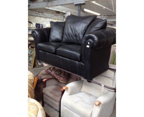 A BLACK LEATHER 2 SEATER SOFA