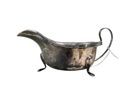 SILVER SAUCE BOAT, SHEFFIELD 1932 with scroll handle on three hoof feet, along with a circular napkin ring (2)Qty: 114g gross
