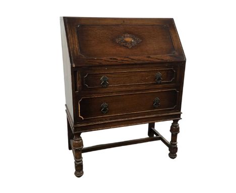 OAK BUREAU, WYLLIE & LOCHHEAD  with carved fall front and two drawers101cm high, 78cm wide