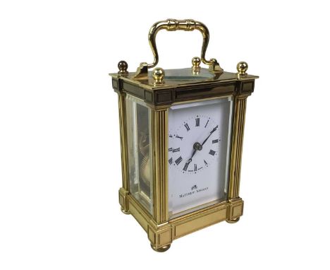 BRASS CARRIAGE CLOCK, MATTHEW NORMAN with white enamel dial13cm highBase is 9cm x 7cm, with a winding movement and winding ke