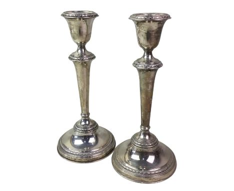 PAIR OF SILVER CANDLESTICKS, ADIE BROTHERS, BIRMINGHAM MARKS with urn shaped nozzles on tapered columns, on circular bases21c
