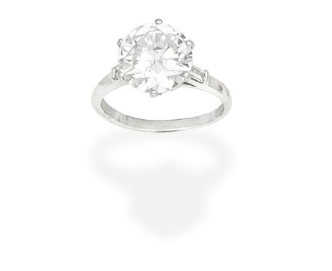 DIAMOND SINGLE-STONE RINGThe old brilliant-cut diamond, weighing 3.64 carats, between baguette-cut diamond shoulders, ring si