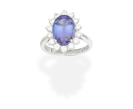 ILIANA: TANZANITE AND DIAMOND CLUSTER RINGThe oval-cut tanzanite within a border of brilliant-cut diamonds, signed Iliana, en