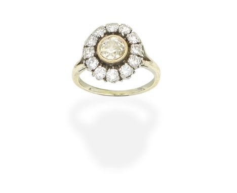 DIAMOND CLUSTER RINGSet with a cushion-shaped diamond of brown tint, within a surround of brilliant-cut diamonds,  diamonds a