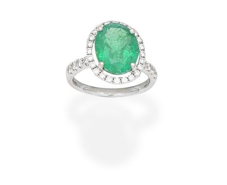 EMERALD AND DIAMOND CLUSTER RINGThe oval-cut emerald within an openwork surround of brilliant-cut diamonds, between shoulders