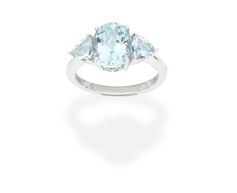 ILIANA: AQUAMARINE THREE-STONE RINGThe oval-cut aquamarine between triangular-cut aquamarine shoulders, signed Iliana,  ring 