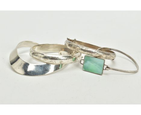 FOUR WHITE METAL BANGLES, to include two foliate engraved hinged bangles, each with an additional safety chain both stamped 9