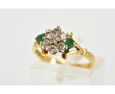 AN 18CT GOLD, DIAMOND AND EMERALD CLUSTER RING, designed as a lozenge shape set with seven round brilliant cut diamonds, flan