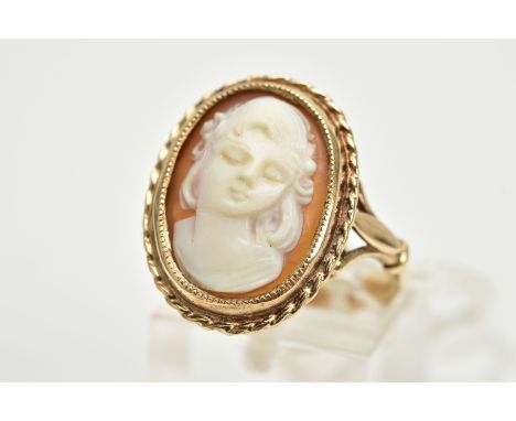 A 9CT GOLD CAMEO RING, of oval design depicting a lady in profile, within a collet mount and rope twist surround, trifurcated