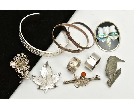 A SELECTION OF WHITE METAL ITEMS, to include a bangle with square detailing all round stamped 925, two children's engine turn