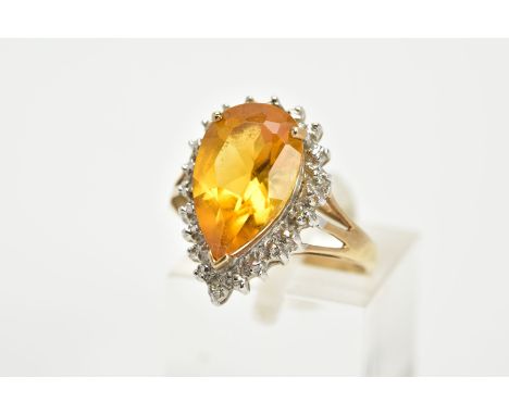 A 9CT GOLD CITRINE CLUSTER RING, designed with a central claw set, pear cut citrine, within a single cut diamond detailed sur