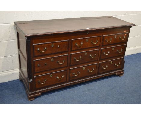 A GEORGE III OAK AND MAHOGANY CROSSBANDED MULE CHEST, with six dummy drawers above three drawers, brass swan neck handles, on