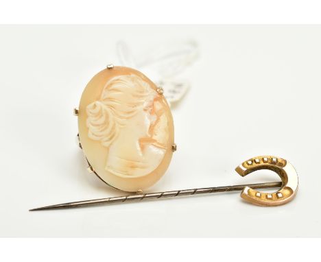 A CAMEO RING AND A STICK PIN, the yellow metal, claw set cameo of oval design, depicting a lady in profile, trifurcated shoul