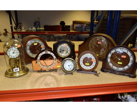 NINE VARIOUS 20TH CENTURY CLOCKS AND TIMEPIECES, including a Kundo anniversary clock, a Smiths brown bakelite dome top clock,