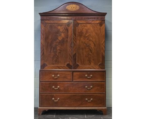 * Linen Press. George III period mahogany linen press, the shell inlaid arched cornice above two doors enclosing shelves over