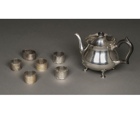 * Teapot. Edwardian silver teapot by Goldsmiths and Silversmiths Company, London 1905, of ogee form with ebony handle and fin