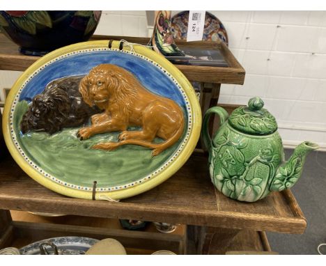 * Majolica. 19th-century majolica pottery wall plaque, with two recumbent lions, on a grassy ground within a yellow border, 2