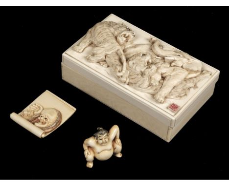 * Box. Japanese ivory box, Meiji period (1868-1912), finely carved in relief with tigers fighting an elephant, with red seal 