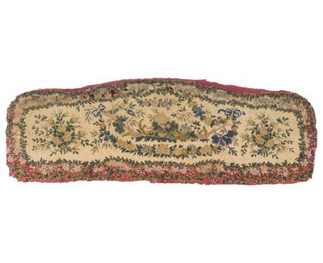 * Needlework. A 19th century French canapé back, hand-worked in polychrome threads in gros point on canvas, with beribboned f