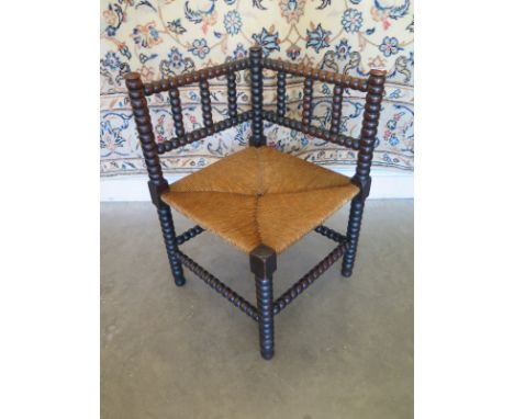 A bobbin turned corner chair with rush seat - 66cm H x 42cm x 42cm  - in clean condition 