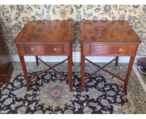 A pair of mahogany lamp tables each with a single drawer on splayed supports united by stretchers, 66 cm tall 56 cm wide, 56 