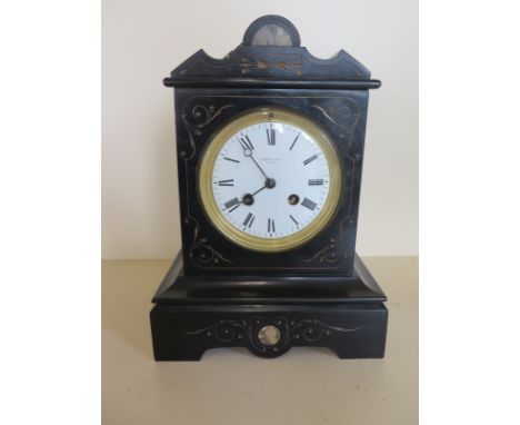 A Rowell and Co. Oxford, black slate mantle clock with eight hour movement, with pendulum and key, approximately 27.5 cm high