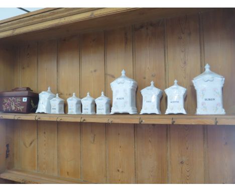 Nine ceramic containers and a decorated tea caddy 