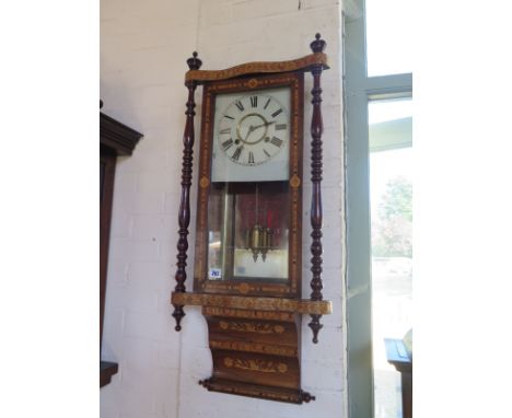 An 8 day American wall clock, the case decorated with boxwood inlay, showing swans to lower trunk, mahogany ring turned pilla