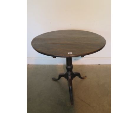 A Georgian elm tilt top tripod table, 69cm tall, 75cm diameter, in need of restoration mainly to base 