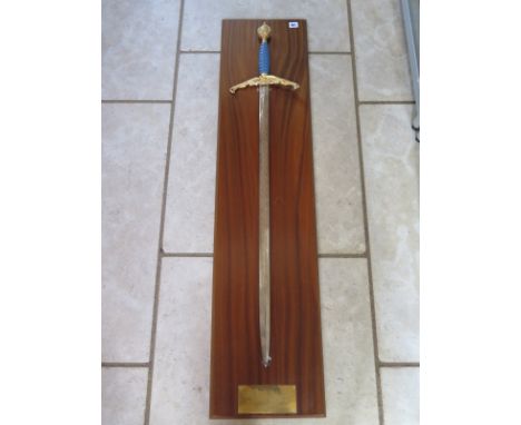 A commemorative WW2 Peace sword by Wilkinson, with engraved blade and wooden presentation wall mount with plaque bearing an i