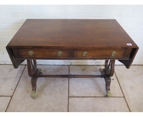 A Georgian style mahogany drop leaf sofa table on large on lyre supports with two active drawers - 70cm tall, 142cm extended 