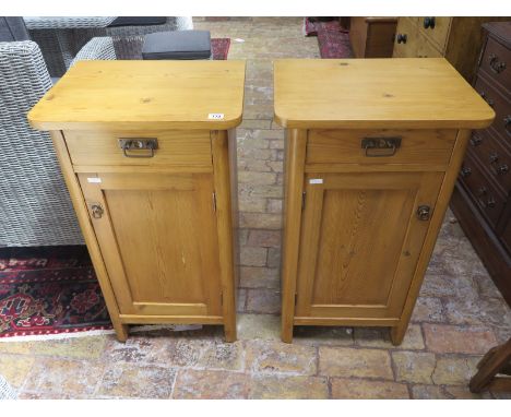A pair of good quality 19th Century stripped and waxed pine bedside cabinets, each with cupboard, with shelf, and drawer abov